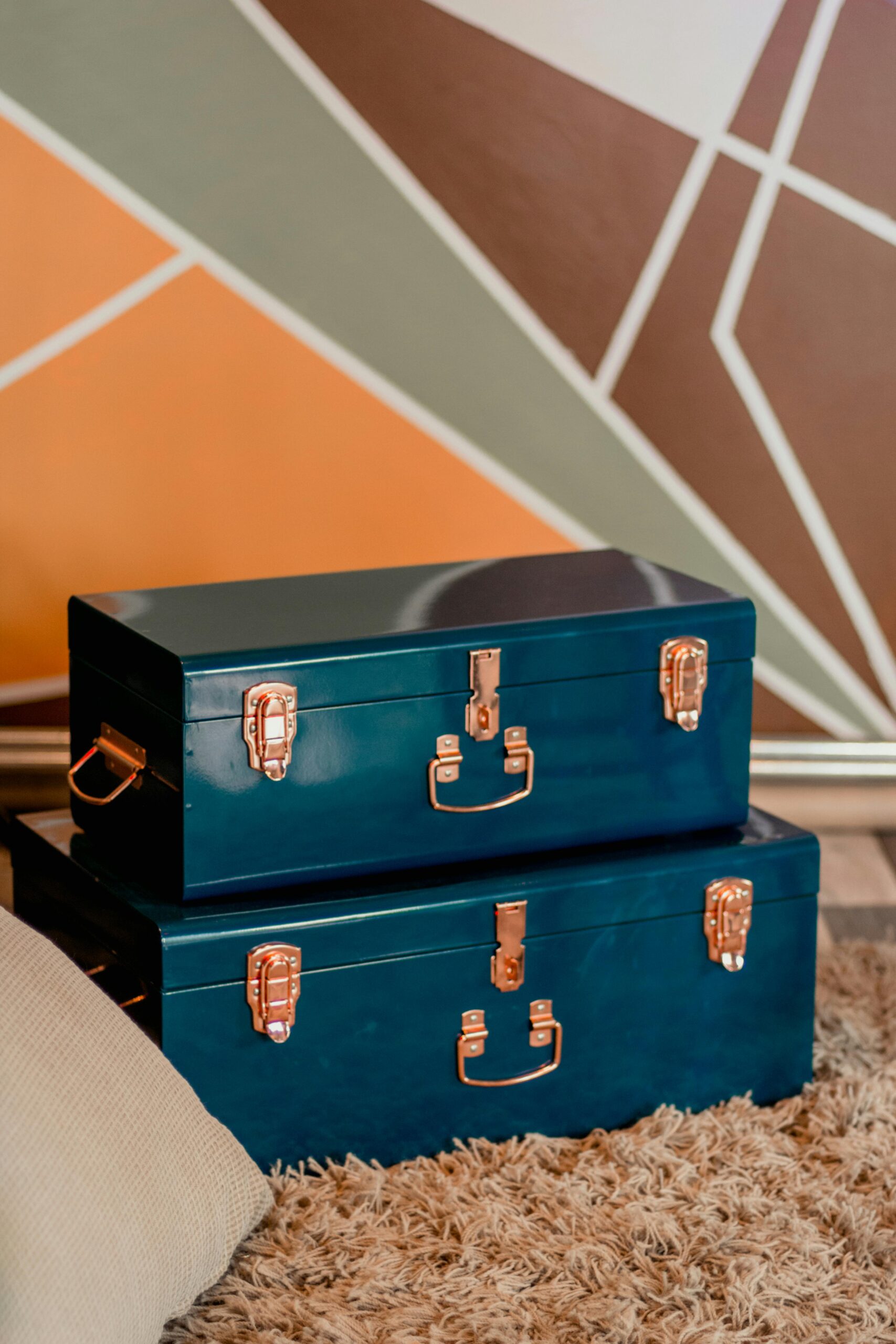 Two vintage blue storage chests set on a cozy carpet in modern indoor decor.